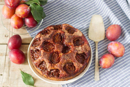 Plum pie or cake with cinnamon and sugar. Plum cake from the newspaper New York Times . Selective focus.の写真素材