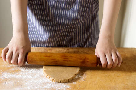 Woman rolling dough for gingerbread.の写真素材