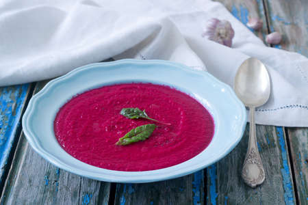 Beet cream soup with garlic. Rustic style, selective focus.
