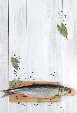 Herring with spices on a wooden board. The background. Rustic style, selective focus.の写真素材