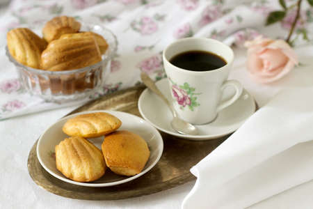 Madeleine, served with coffee. Traditional French pastries. Romantic breakfast. Style ryustik, selective focus.の写真素材