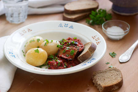 Appetizer from aubergines in a sauce of peppers and tomatoes, served with boiled potatoes. Rustic...