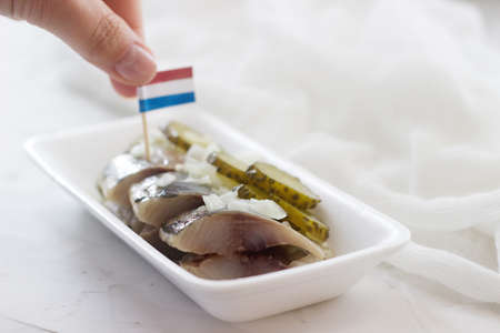 Dutch herring with onion and pickled cucumber. Selective focus.の写真素材