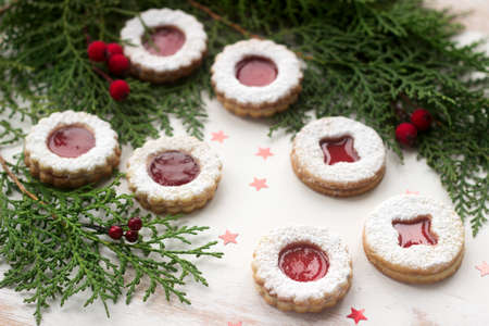 Linzer cookies in a Christmas decoration on a wooden surface. Rustic style, selective focus.の写真素材
