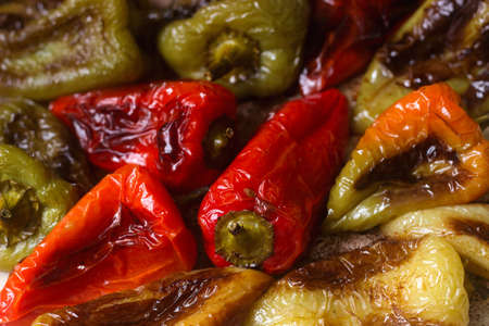 Baked bell peppers of different colors with vegetable oil and herbs on a baking sheet. Selective focus.の写真素材