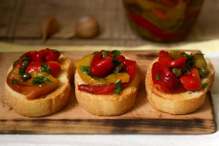Fresh and tasty bruschetta with pickled bell pepper, capers and parsley.の写真素材