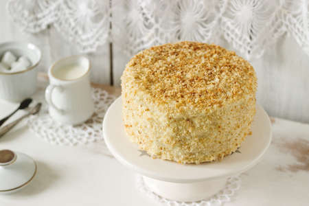 Napoleon cake made of puff pastry and custard vanilla cream on a white background. Rustic style,...