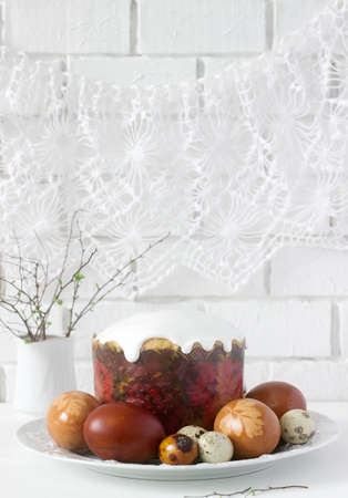 Easter still life with Easter cake kulich and painted eggs on a light background. Selective focus.