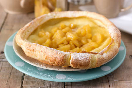 Dutch baby pancake with apple-cinnamon sauce. Selective focus.の写真素材