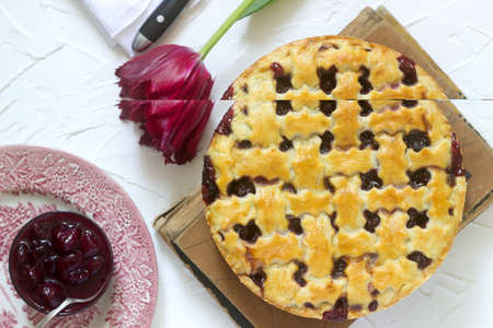 A traditional American or European cherry pie made of shortcake. Rustic style, selective focus.の写真素材