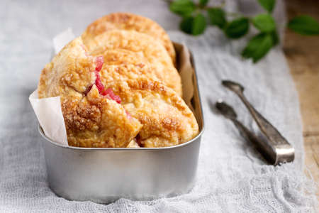 Crispy mini pies with apple and red currant. Rustic style, selective focus.の写真素材