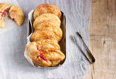 Crispy mini pies with apple and red currant. Rustic style, selective focus.の写真素材