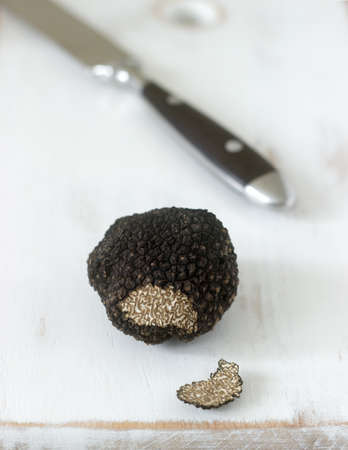 Mushroom black truffle on a wooden table. Found in Moldova in July 2018. Selective focus.の写真素材