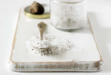 Sea salt with truffle and truffle on a light background. Rustic style, selective focus.