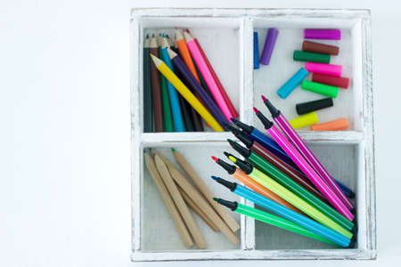 Accessories for children's art pencils and markers on a white background. Selective focus.