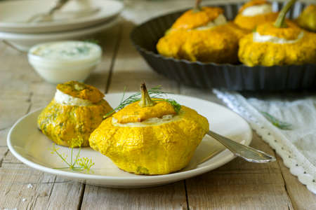 Pattypan squash or pumpkins stuffed with ricotta with basil and dill and served with sour cream...