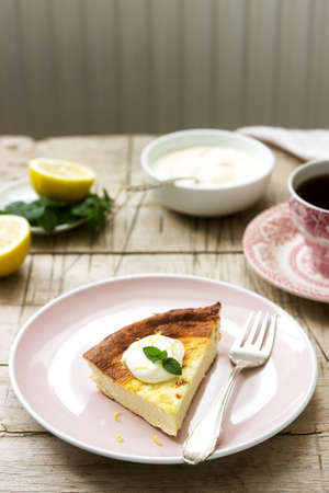 Healthy breakfast made from soft cottage cheese casserole with oatmeal and lemon zest, served with sour cream and mint.の写真素材