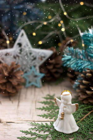 Winter composition with branches of juniper and thuja and Christmas toys on a wooden background. Rustic style, selective focus.の写真素材