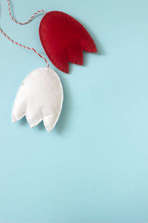 Spring symbol Martenitsa or martisor consisting of red and white pieces, traditional for Romania, Moldova, Bulgaria and the Balkan countries. Selective focus.の写真素材