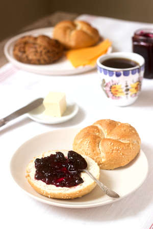 Breakfast with Kaiser rolls, currant jam, butter and cheese and tea. Selective focus.の写真素材