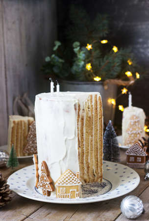 Homemade honey cake with sour cream, decorated with gingerbread. Rustic style.