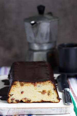 Lviv cheesecake, a traditional Ukrainian dessert with raisins, coated with chocolate icing....