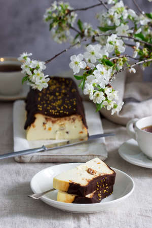 Lviv cheesecake, a traditional Ukrainian dessert with raisins, coated with chocolate icing....