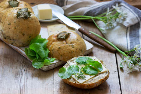 Nettle buns served with butter, cheese and greens. Rustic style.の写真素材