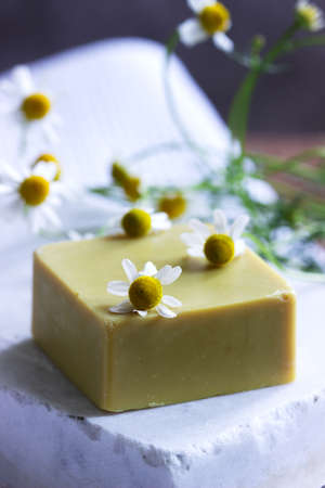 Handmade soap with medicinal herbs, flowers and a towel. Selective focus.の写真素材