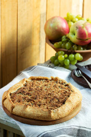 Homemade apple pie with streusel and fresh fruit. Rustic style, selective focus.の写真素材