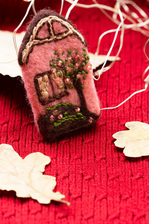 Handmade wool brooch on a sweater background. Selective focus.の写真素材