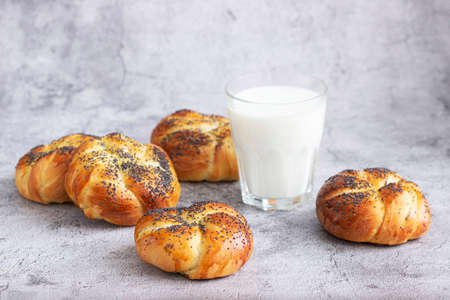 Sweet buns with poppy seeds served with milk.の写真素材