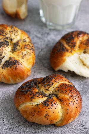 Sweet buns with poppy seeds served with milk.