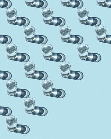 Pattern from glasses with water on a blue background. Ecological concept.の写真素材
