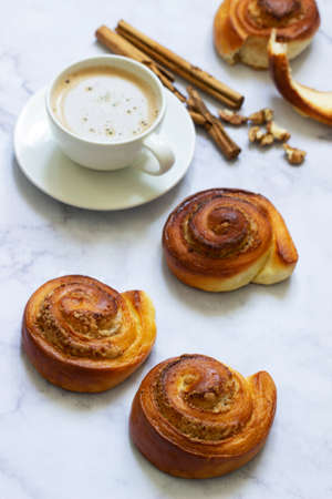 Cinnamon rolls with nut filling, served with coffee.