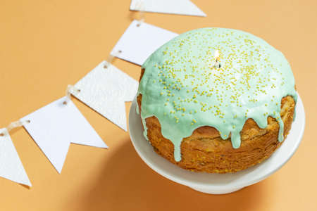 Easter cake covered with icing on a cake bowl and Easter eggs. Festive concept.