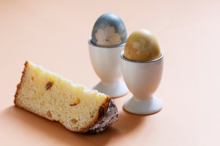 Easter still life, a slice of Easter cake and eggs dyed with natural dyes. Selective focus.