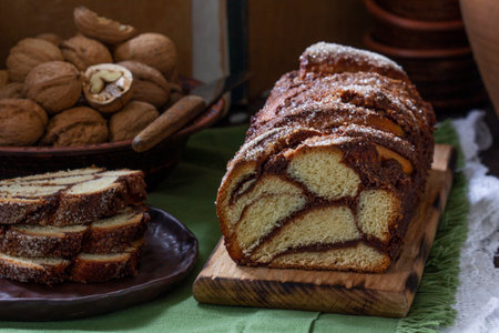 Traditional Easter bread with chocolate and nut filling on a wooden background. Rustic style, selective focus.の写真素材