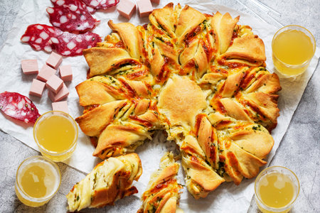 Table for a friendly party, snack star bread with cheese filling, sausage and beer. Selective focus.の写真素材