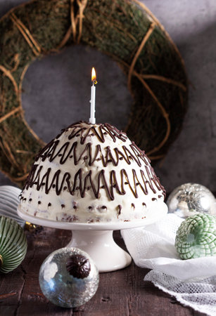 Pancho cake made of chocolate biscuit with sour cream and pineapple in New Year's or Christmas decoration. Rustic style, selective focus.の写真素材