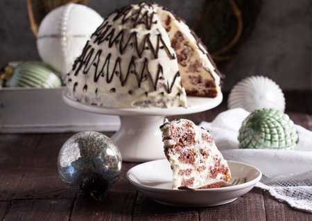 Pancho cake made of chocolate biscuit with sour cream and pineapple in New Year's or Christmas decoration. Rustic style, selective focus.の写真素材