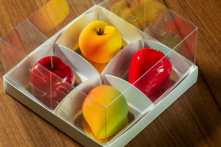 Gift set of mousse cakes in the shape of fruits and berries in a box.の写真素材