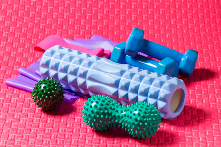 Colorful fitness, pilates or yoga equipment: mat, belts, roller, dumbbells.の写真素材