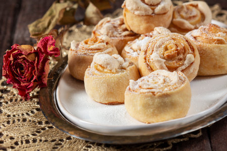 Traditional Moldavian rose-shaped cookies with meringue filling, served on a ceramic plate.