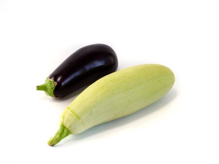 Fresh zucchini and eggplant isolated on white background. Big green zucchini and purple aubergine with shadow and copyspace for text.の写真素材