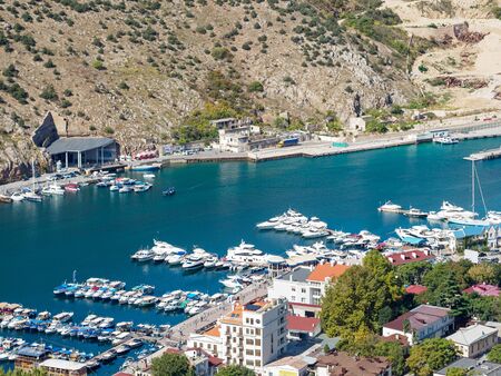 Summer view of Balaklava bay from the hill. Tourist ships and boats at the pier.の写真素材