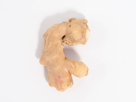 Root of ginger, isolated, on white background. Ginger rhizome in closeup view with copyspace for text.の写真素材