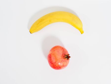 Set of fruits isolated on white background. Pomegranate and banana with copyspace for text.の写真素材