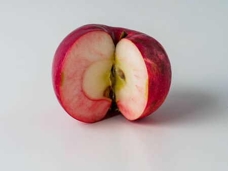 Organic red apple isolated on white background. Fresh fruit from domestic tree. Copyspace for text.の写真素材
