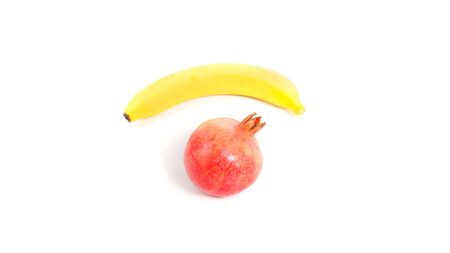 Set of fruits isolated on white background. Pomegranate and banana with copyspace for text.の写真素材